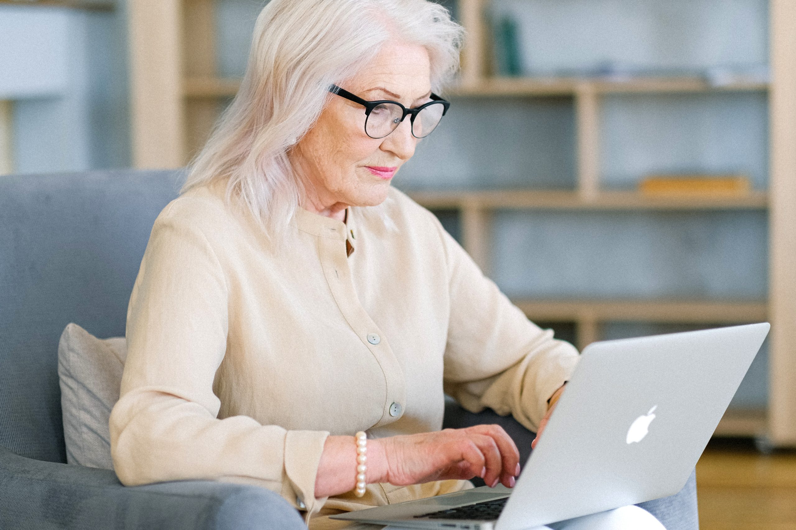 Photo of an elderly lady using her laptop.